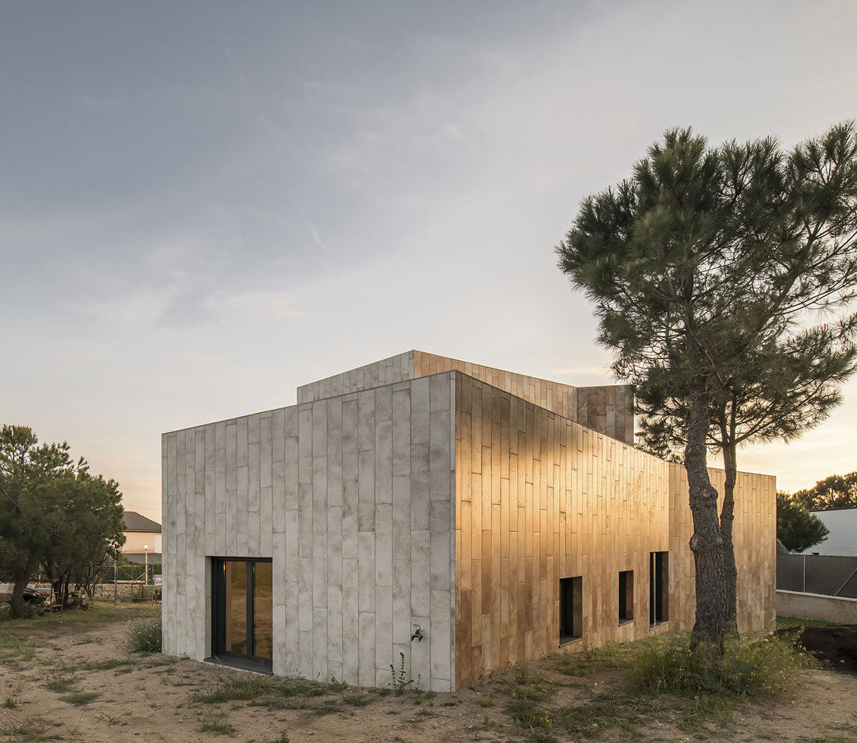 OOIIO Architecture plays with intersection of red ceramic-tiled volumes to create house in Madrid