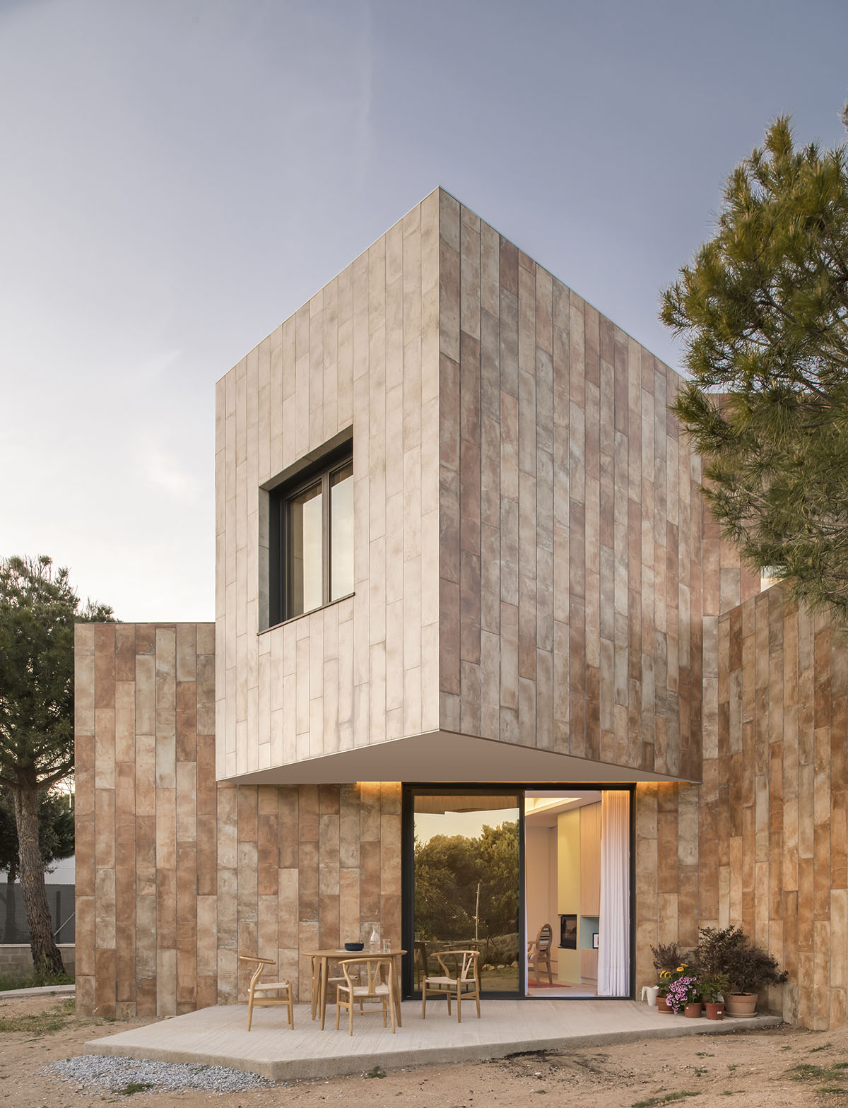 OOIIO Architecture plays with intersection of red ceramic-tiled volumes to create house in Madrid