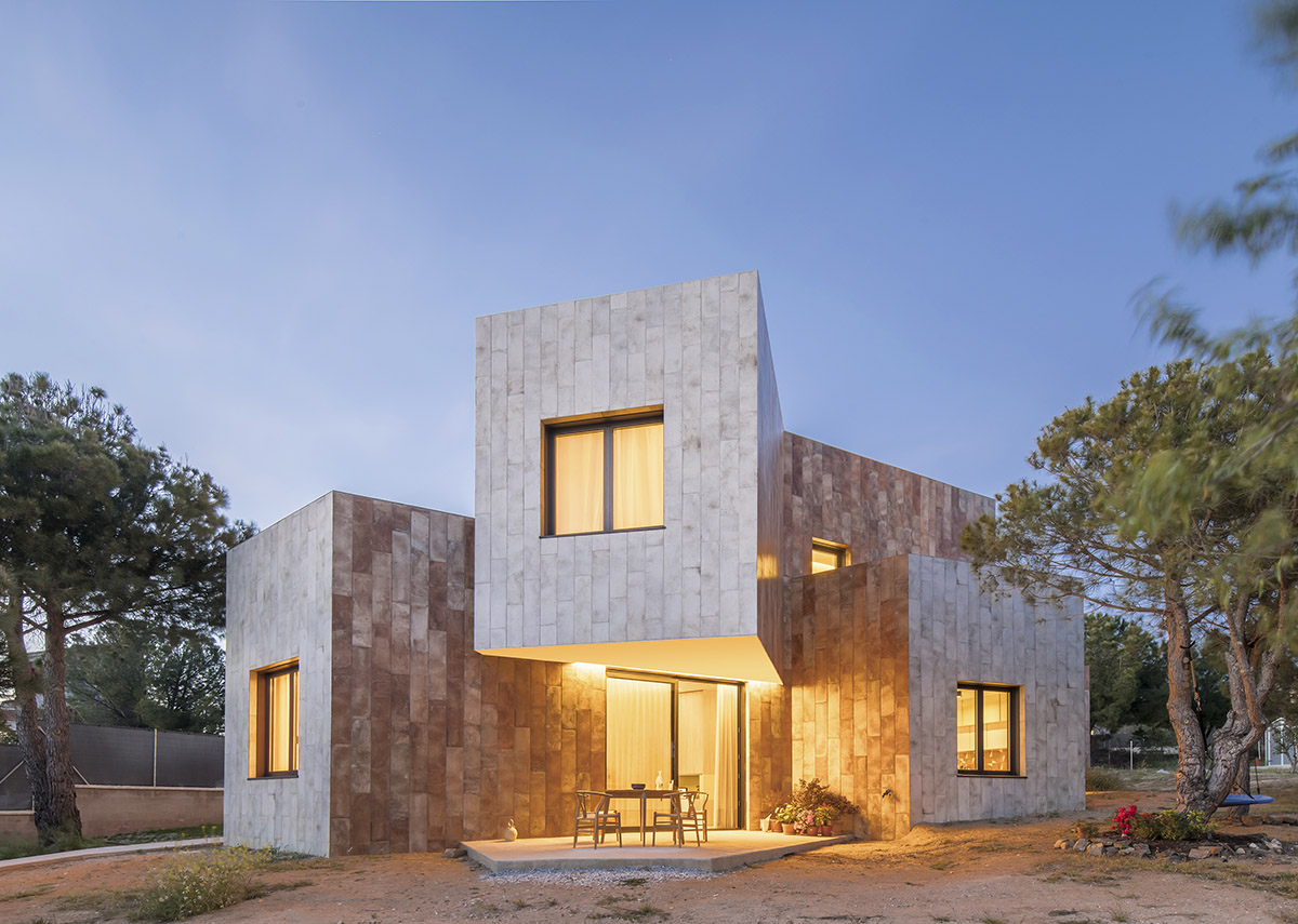 OOIIO Architecture plays with intersection of red ceramic-tiled volumes to create house in Madrid