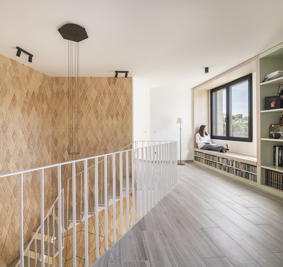 OOIIO Architecture plays with intersection of red ceramic-tiled volumes to create house in Madrid