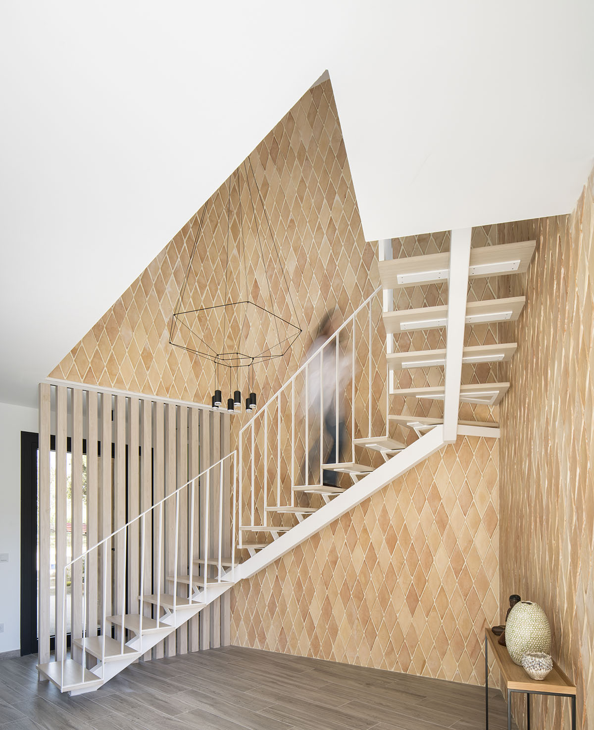 OOIIO Architecture plays with intersection of red ceramic-tiled volumes to create house in Madrid