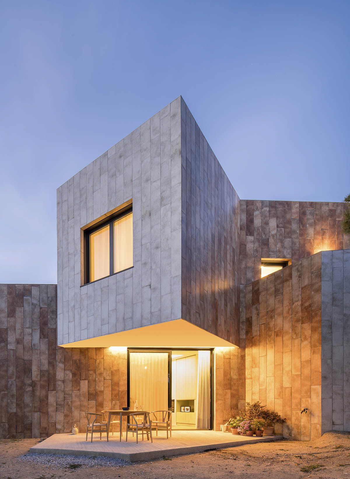 OOIIO Architecture plays with intersection of red ceramic-tiled volumes to create house in Madrid