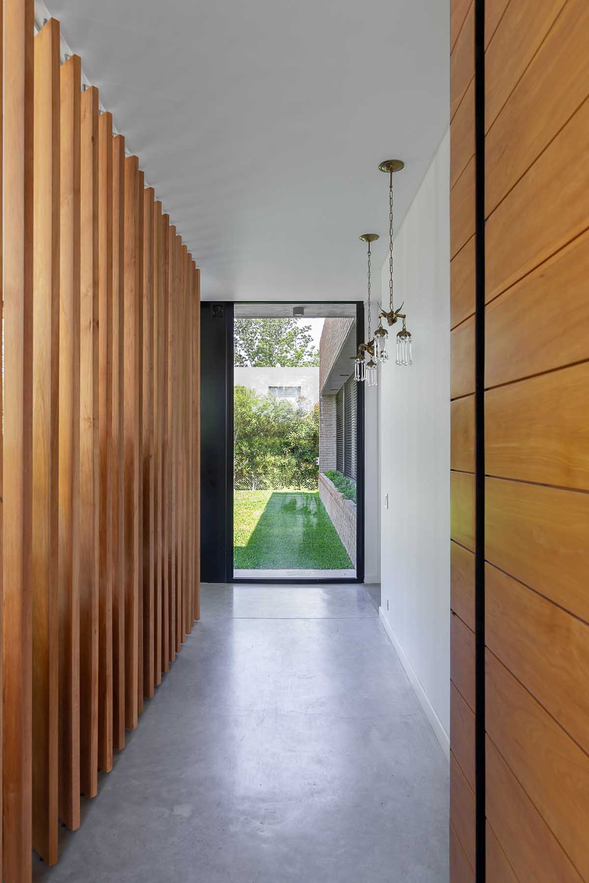 Nómade Arquitectura creates urban filter with large interlocked brick wall for house in Argentina