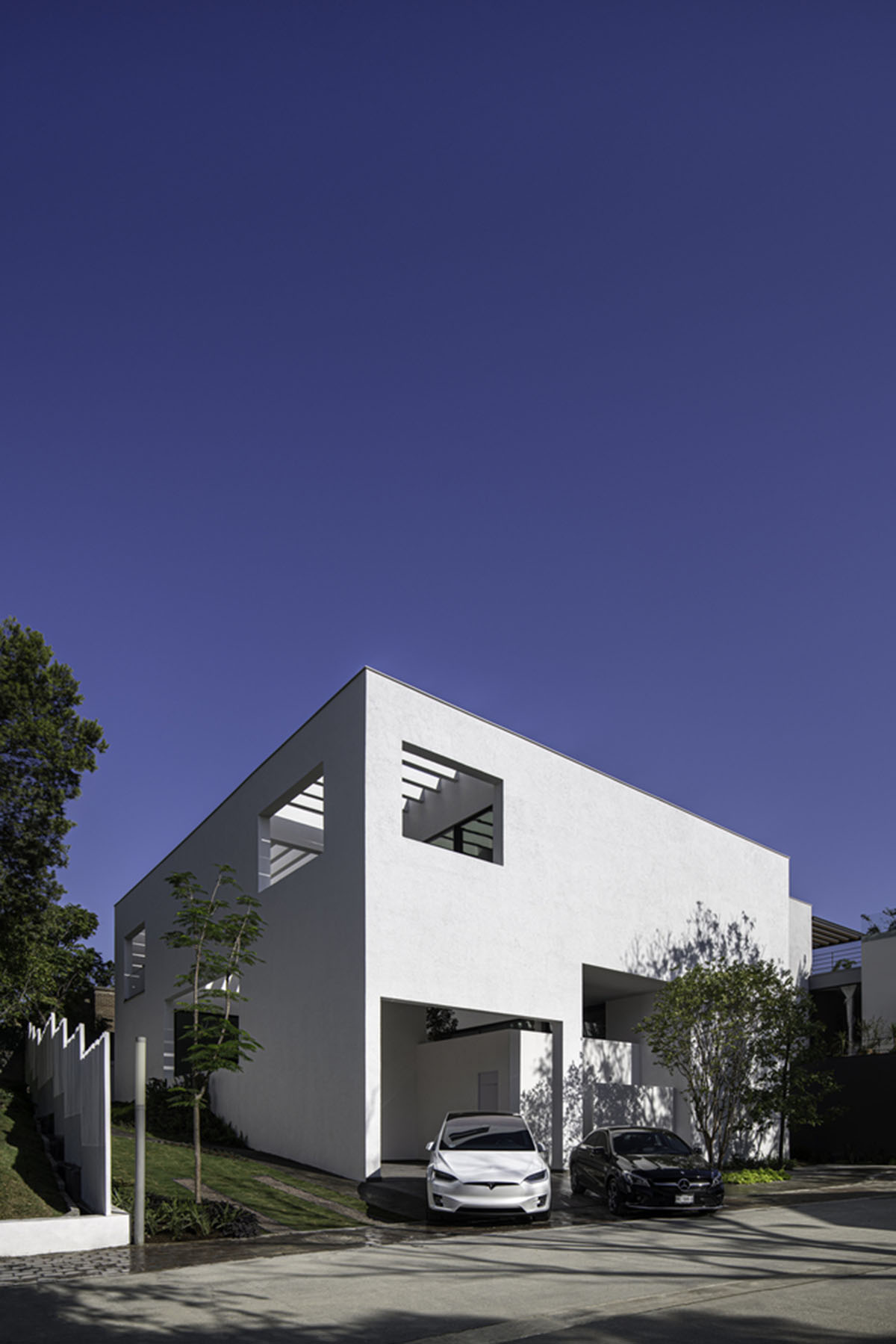 Cadaval & Solà-Morales' white excavated house features porous interior that expands activities