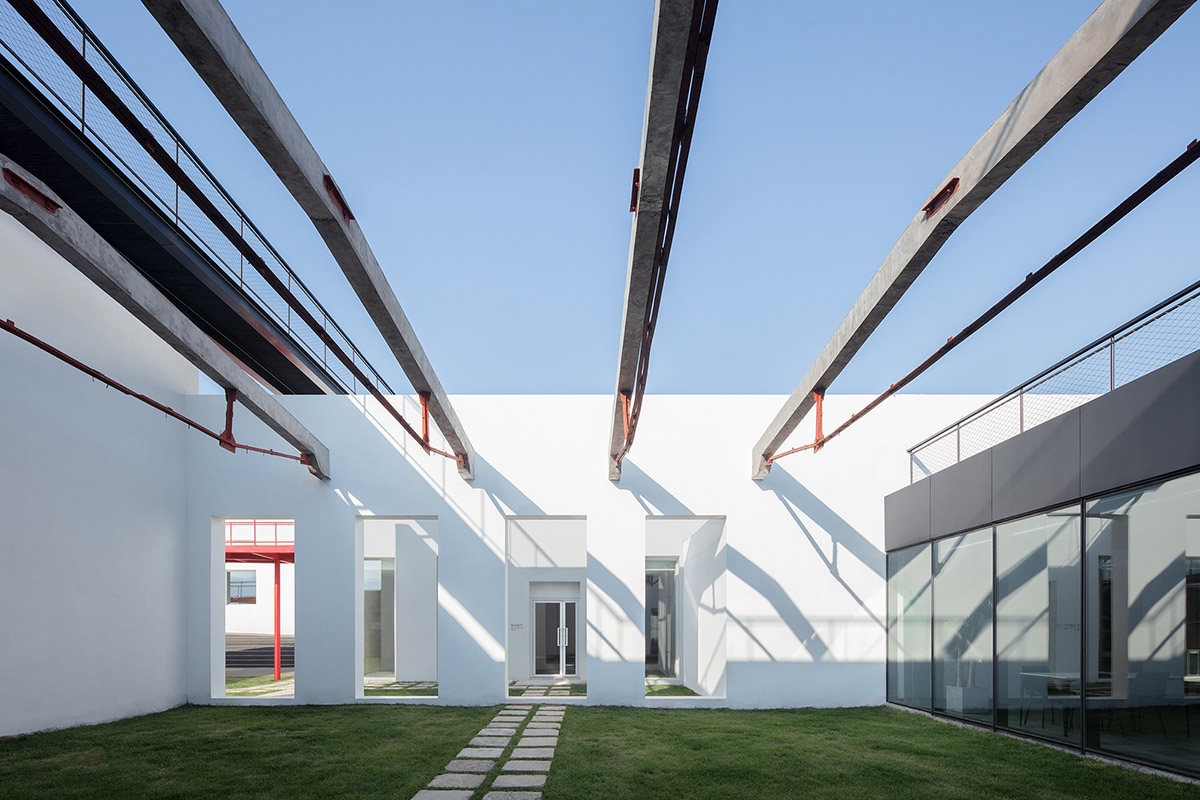 REDe Architects and Moguang Studio add red circular platform to renovated youth activity center