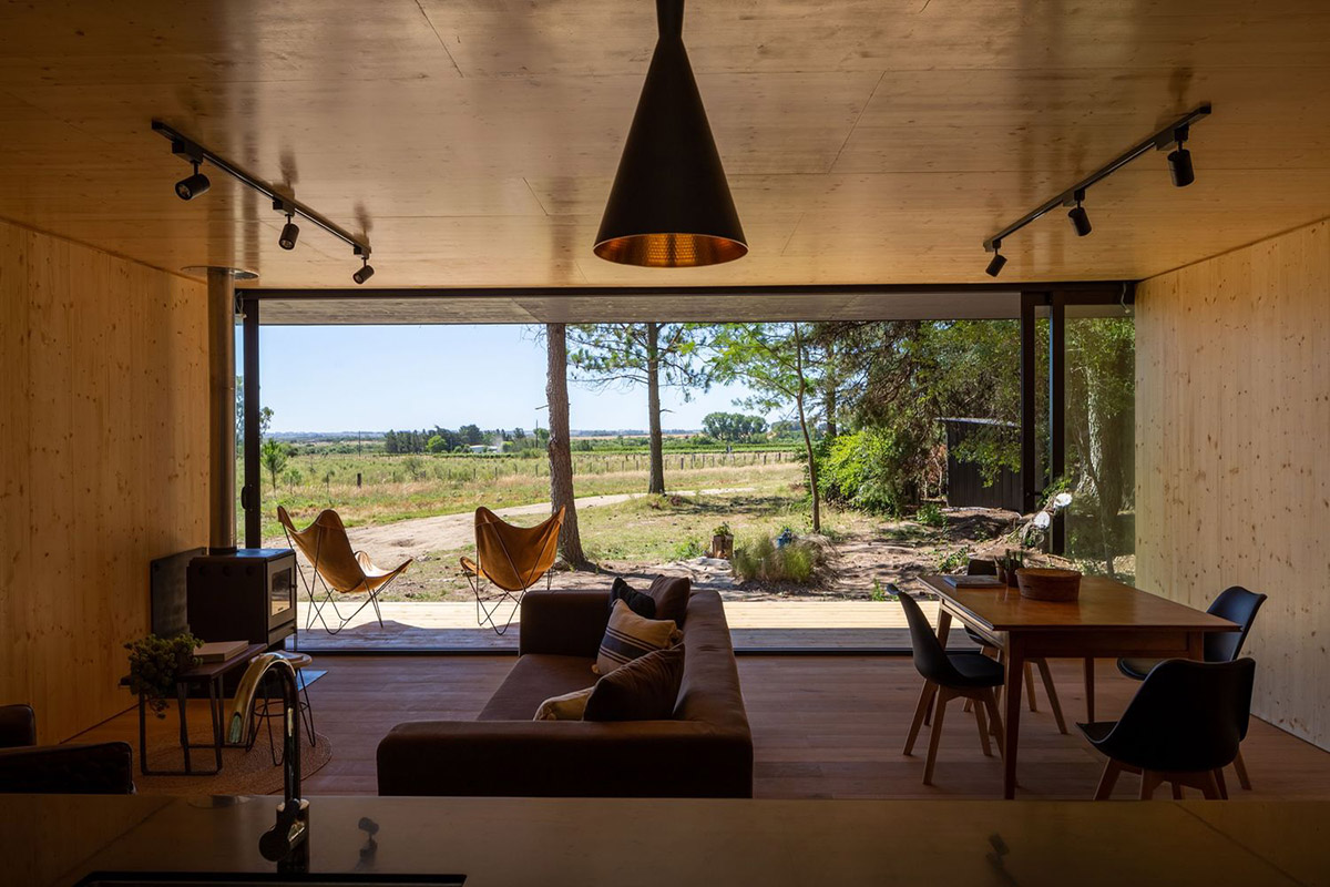 Black wooden cabin by iHouse estudio is an off-grid escape home in Uruguayan native forest