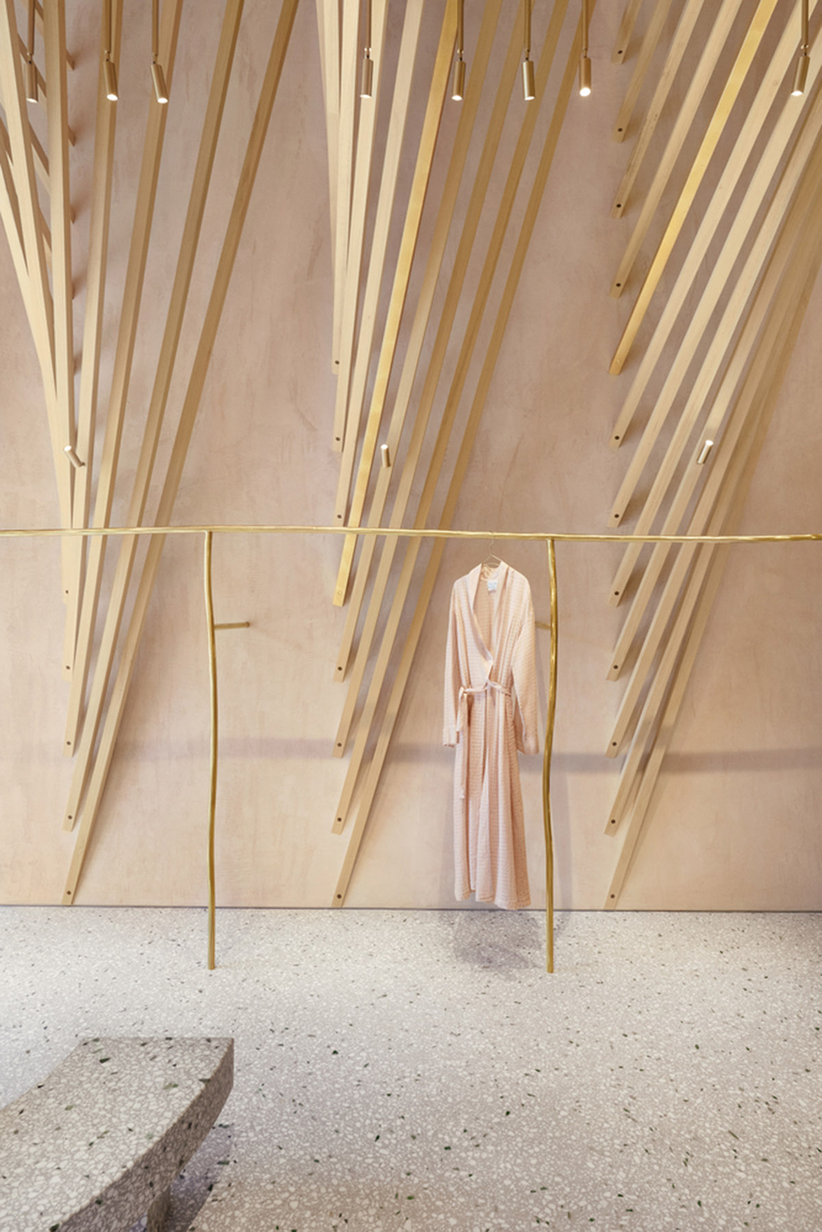 Golden and powder-colored details dominate forte_forte forte dei Marmi boutique in Italy