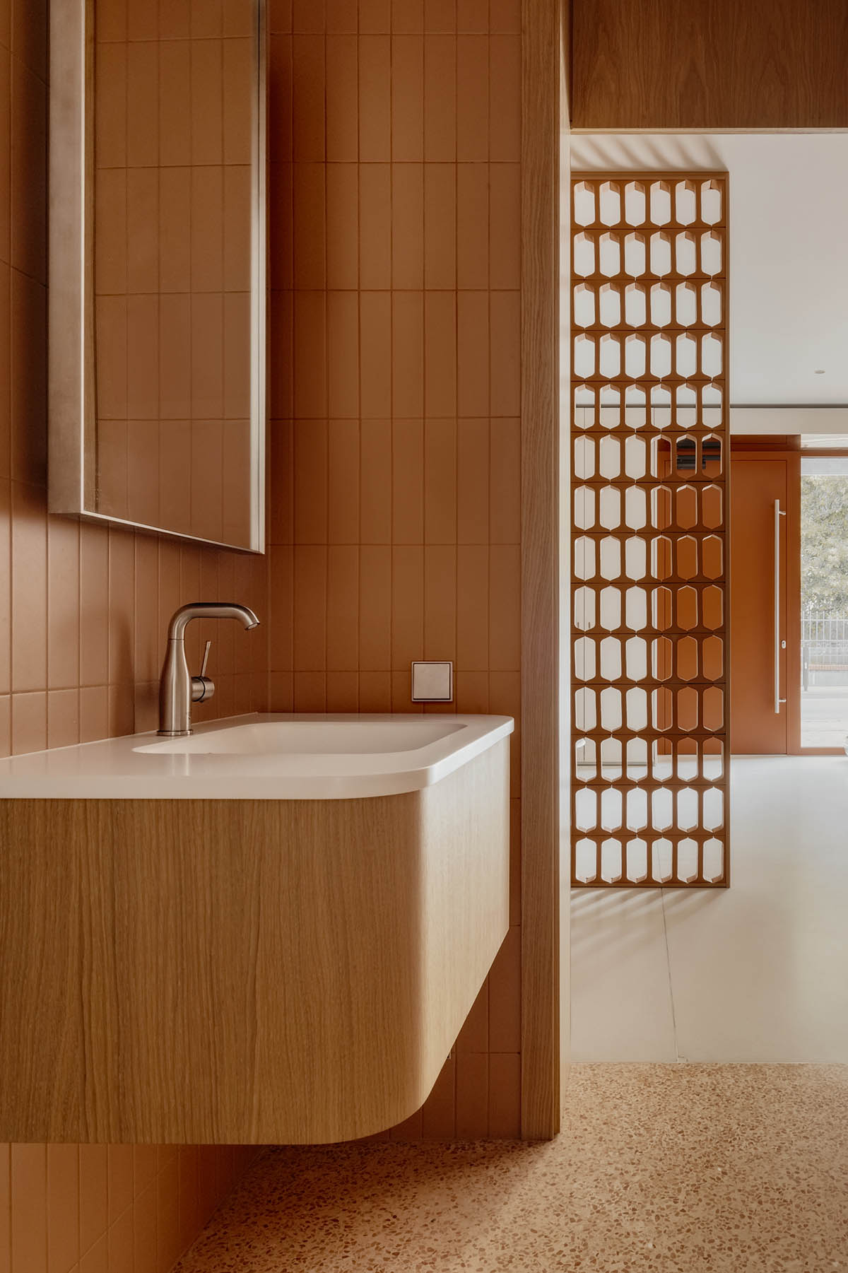 Brise soleil system and clay counter add warmth and depth to dental clinic in Latvia