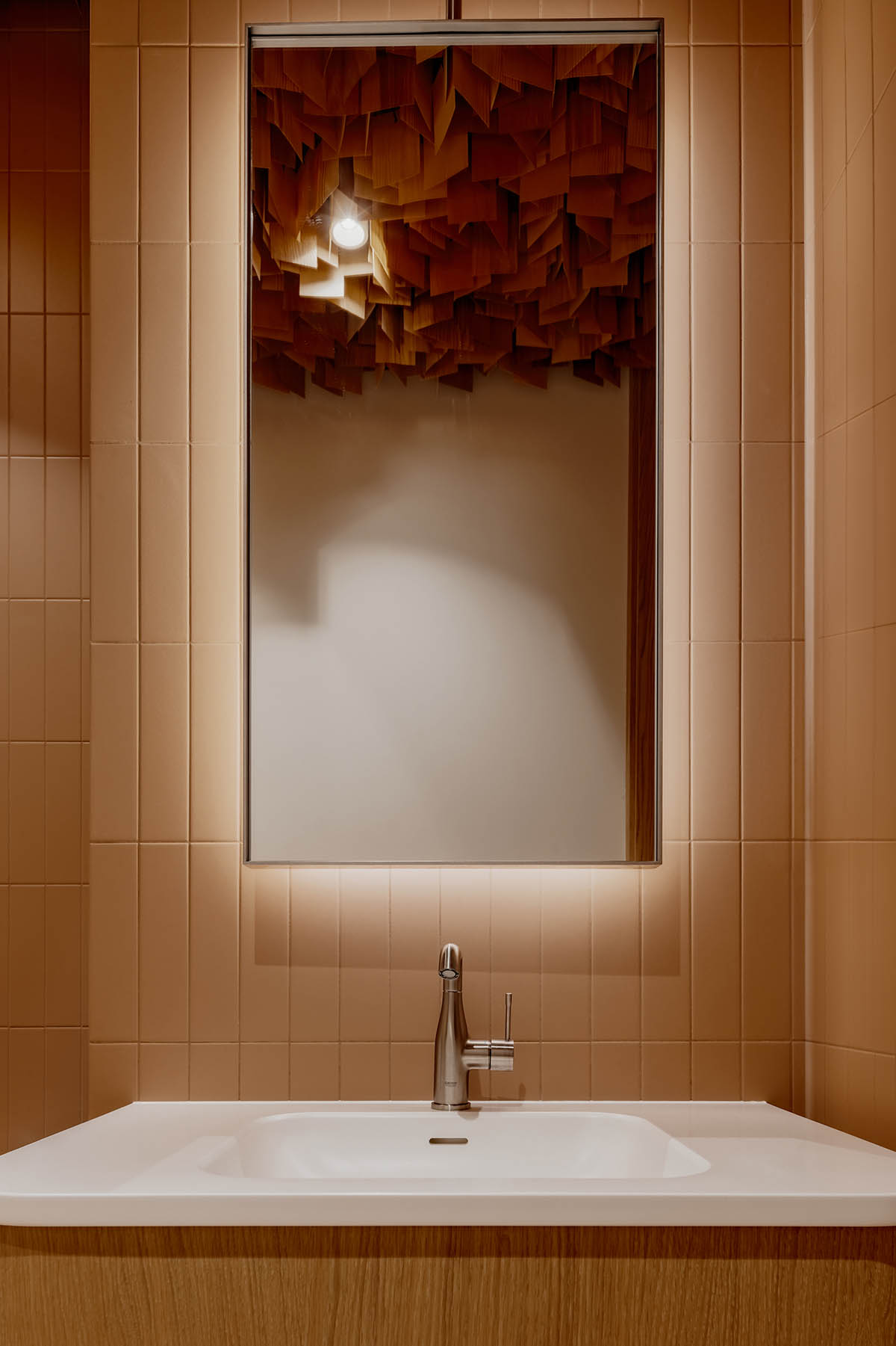 Brise soleil system and clay counter add warmth and depth to dental clinic in Latvia