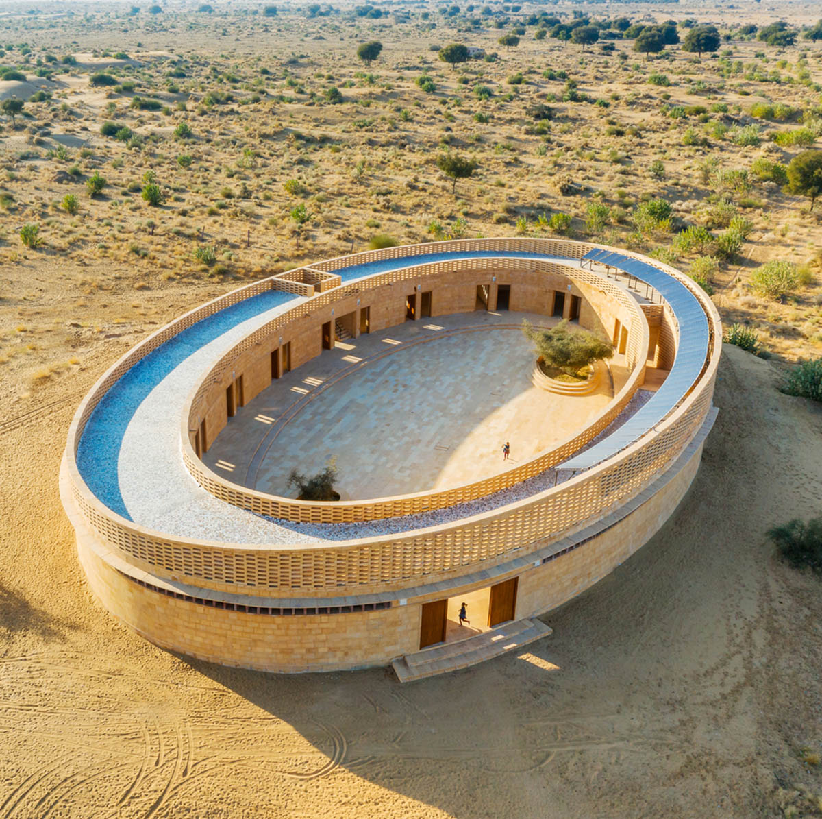 Diana Kellogg Architects' oval-shaped girl's school is made of hand-carved sandstone in rural India