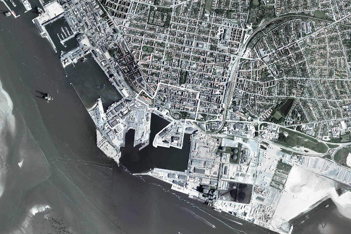 COBE's new pedestrian bridge raised on slim columns in industrial harbour area of Denmark