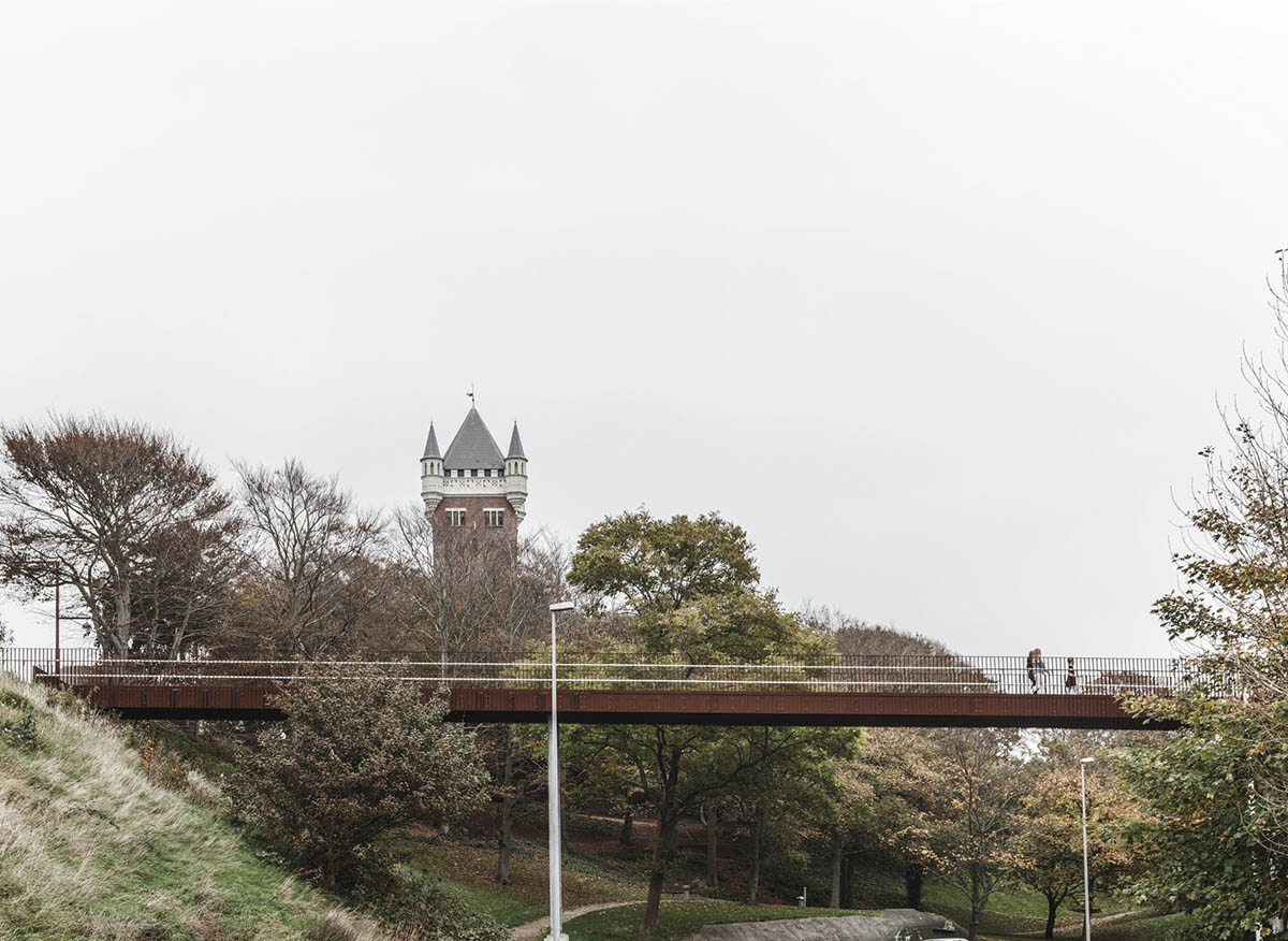 COBE's new pedestrian bridge raised on slim columns in industrial harbour area of Denmark