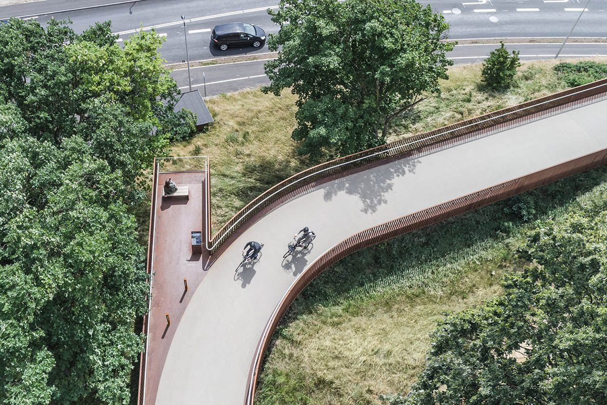 COBE's new pedestrian bridge raised on slim columns in industrial harbour area of Denmark
