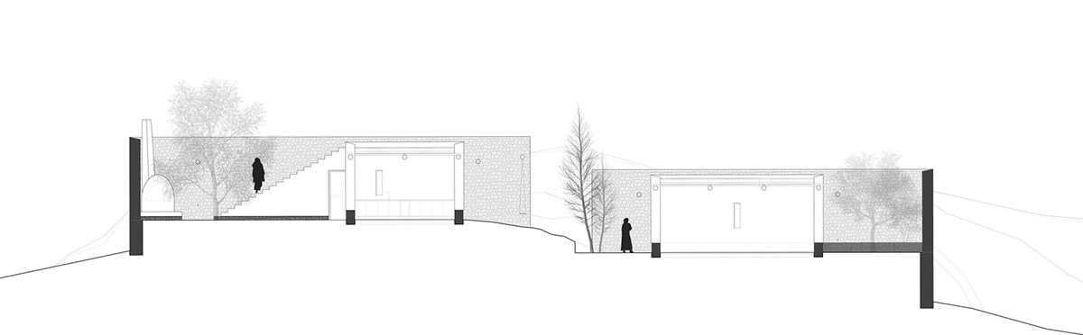 Two elongated walls made of granite rocks and earth form this women's house in a village of Morocco