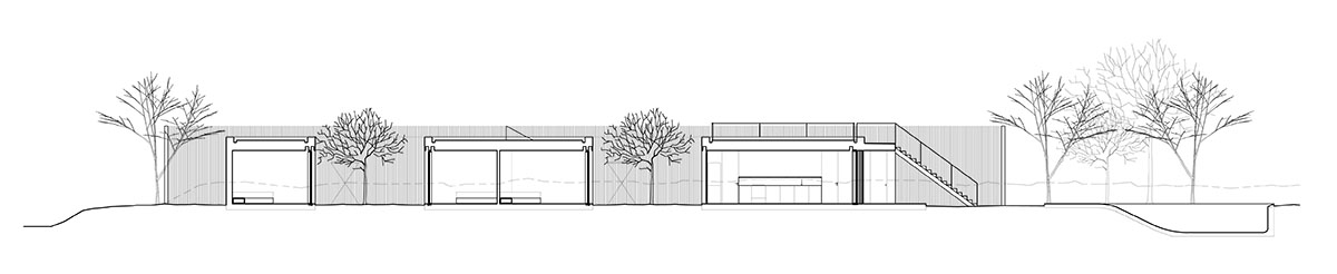 Palisade House is wrapped by a long palisade in fir wood to protect dunes in Troia, Portugal 