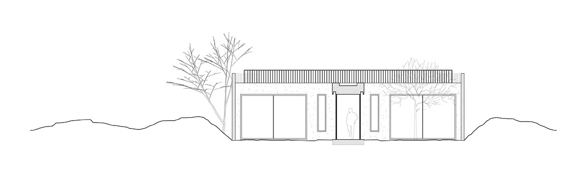 Palisade House is wrapped by a long palisade in fir wood to protect dunes in Troia, Portugal 