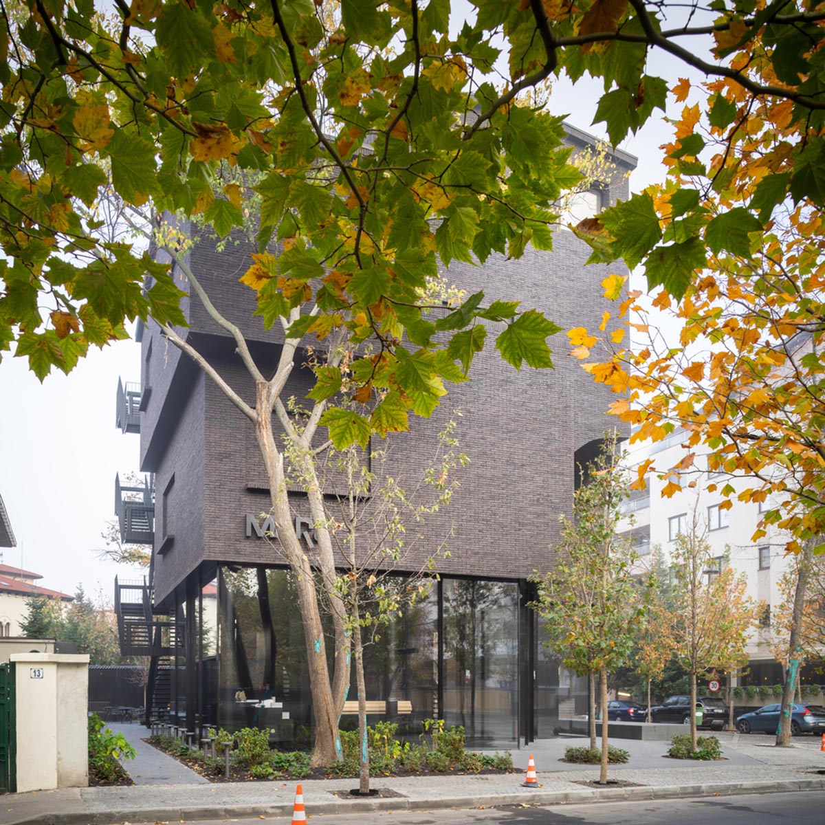 YTAA converts old villa into a museum with irregular dark surfaces and glazed base in Bucharest