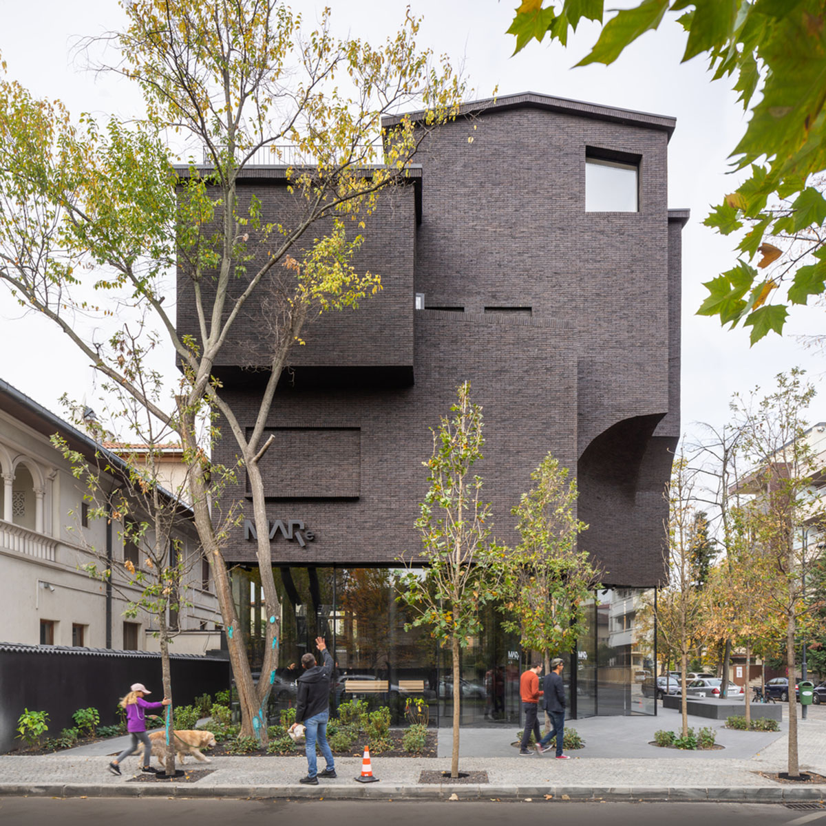 YTAA converts old villa into a museum with irregular dark surfaces and glazed base in Bucharest