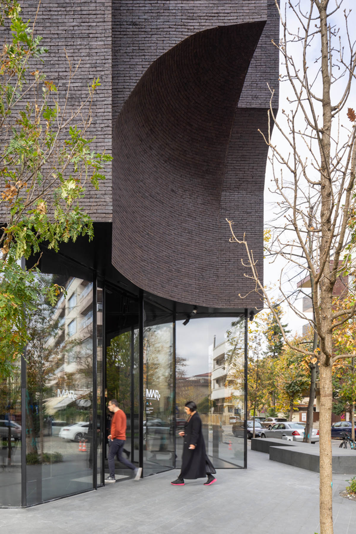 YTAA converts old villa into a museum with irregular dark surfaces and glazed base in Bucharest