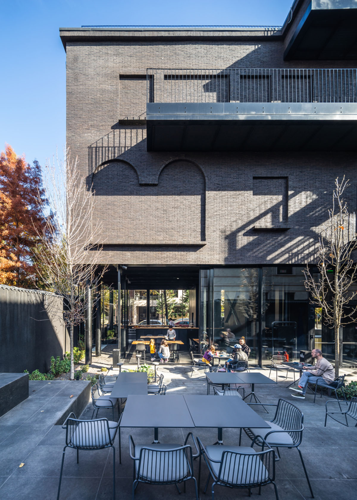 YTAA converts old villa into a museum with irregular dark surfaces and glazed base in Bucharest