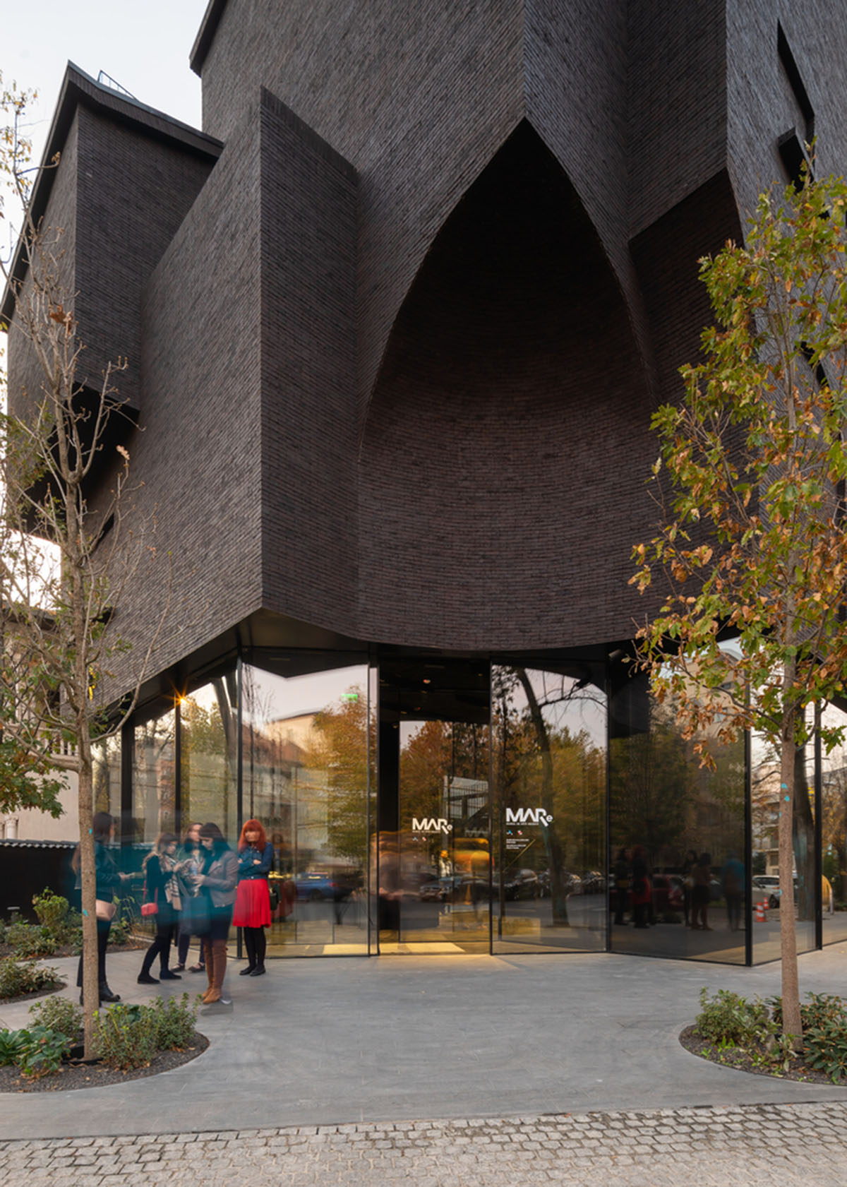 YTAA converts old villa into a museum with irregular dark surfaces and glazed base in Bucharest