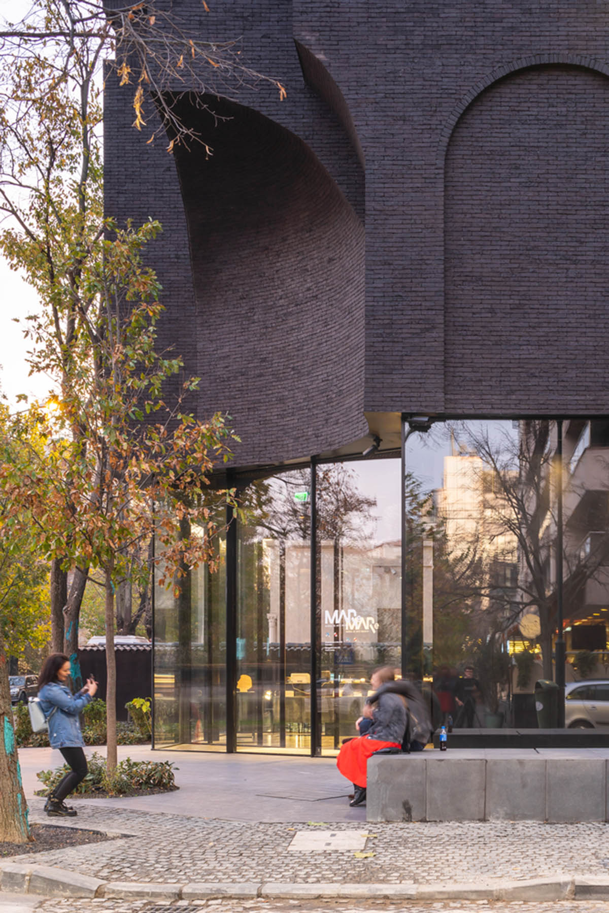 YTAA converts old villa into a museum with irregular dark surfaces and glazed base in Bucharest