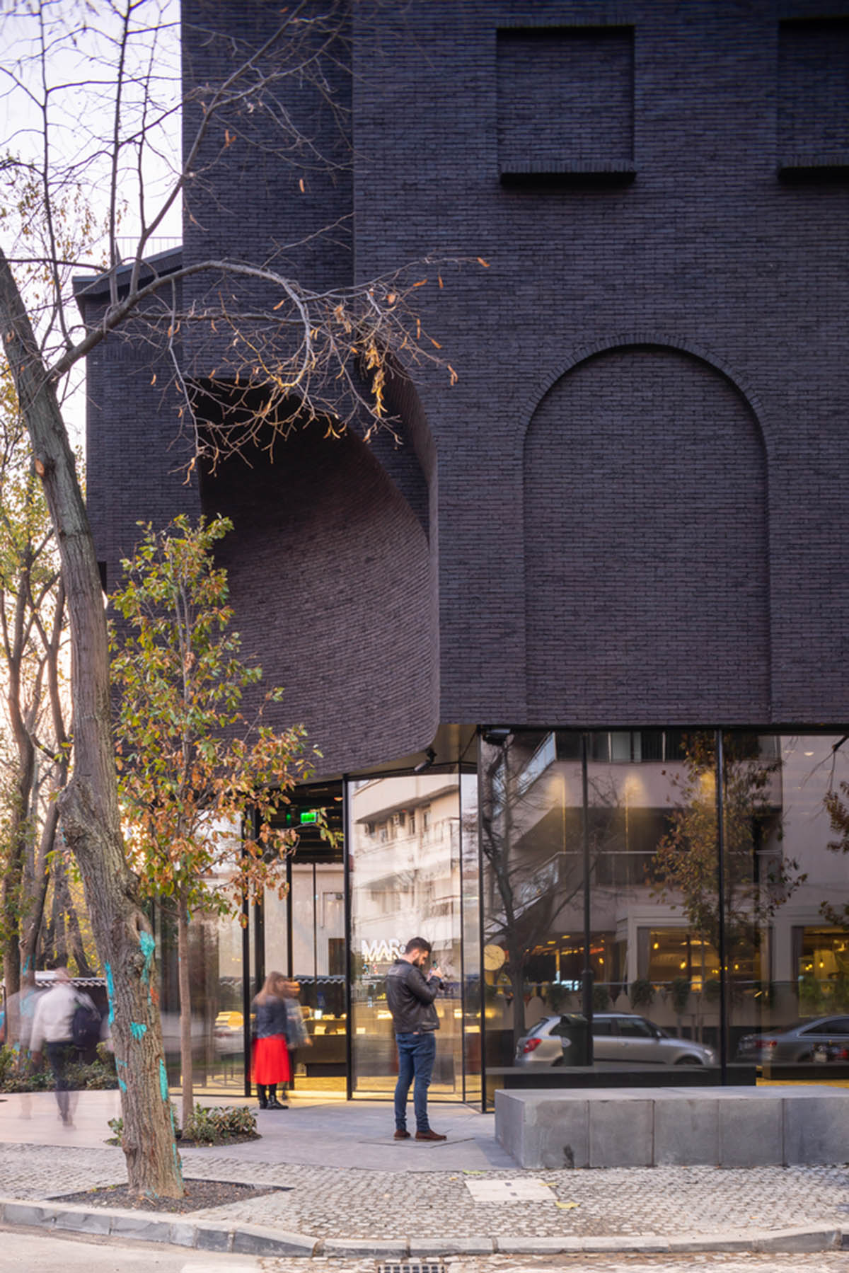 YTAA converts old villa into a museum with irregular dark surfaces and glazed base in Bucharest