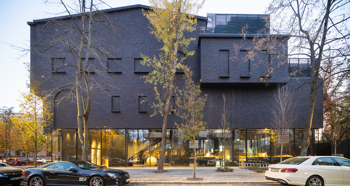 YTAA converts old villa into a museum with irregular dark surfaces and glazed base in Bucharest