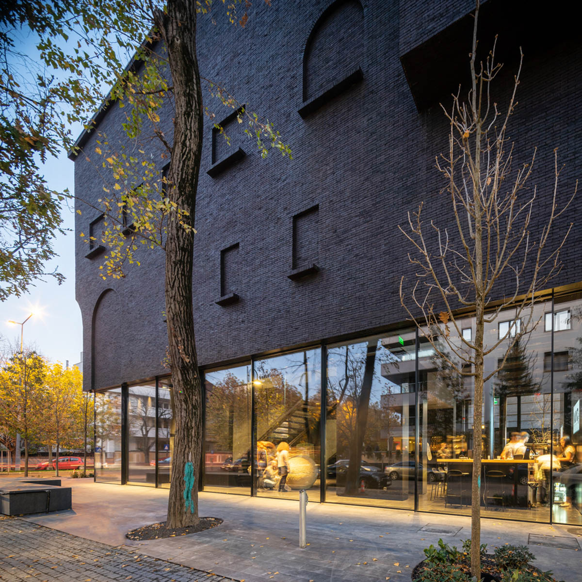 YTAA converts old villa into a museum with irregular dark surfaces and glazed base in Bucharest