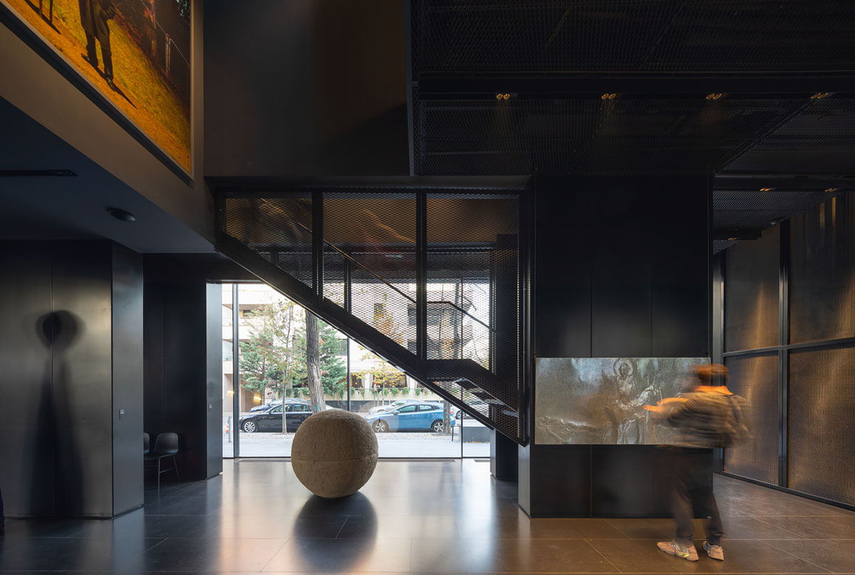 YTAA converts old villa into a museum with irregular dark surfaces and glazed base in Bucharest