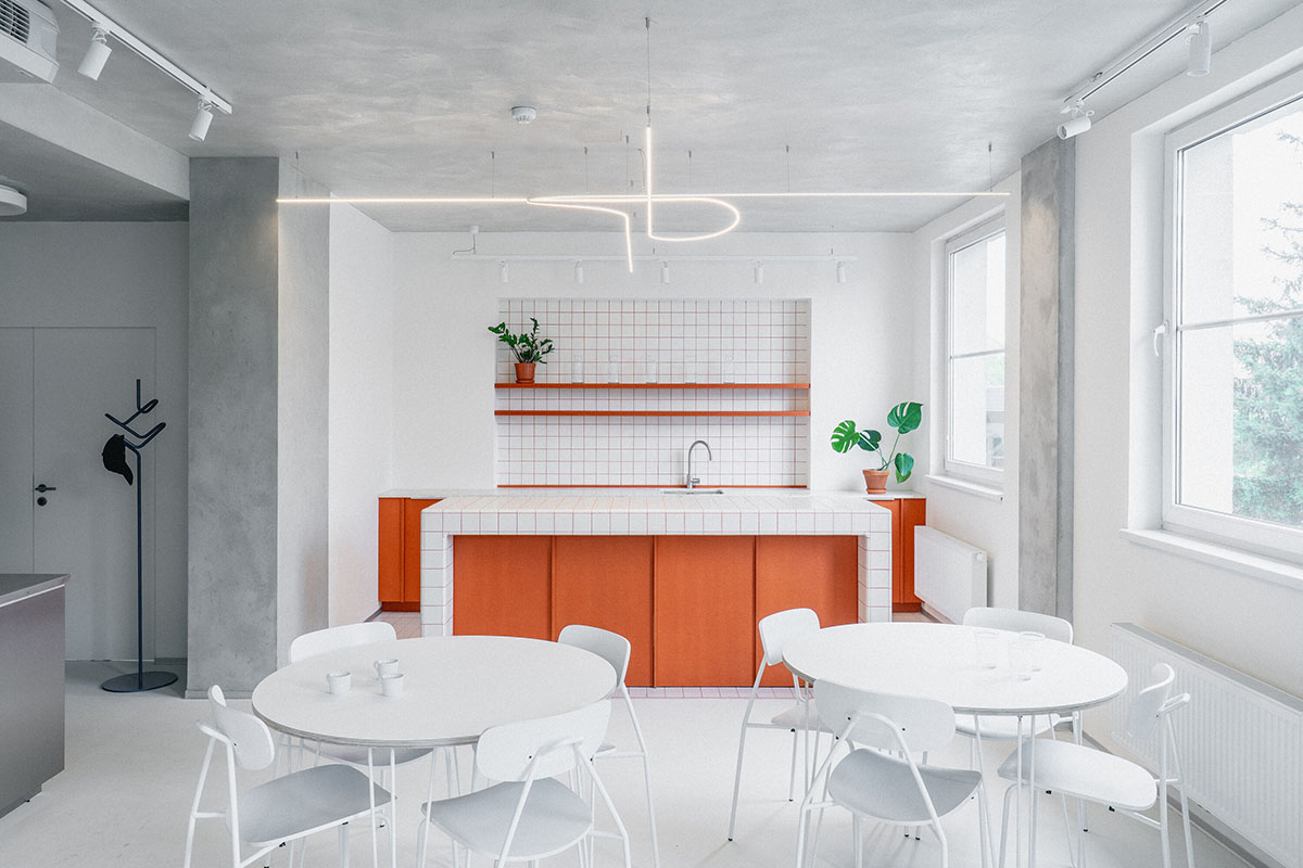 Studio Cosmo revitalizes Pudis offices featuring a stainless steel backdrop in Prague