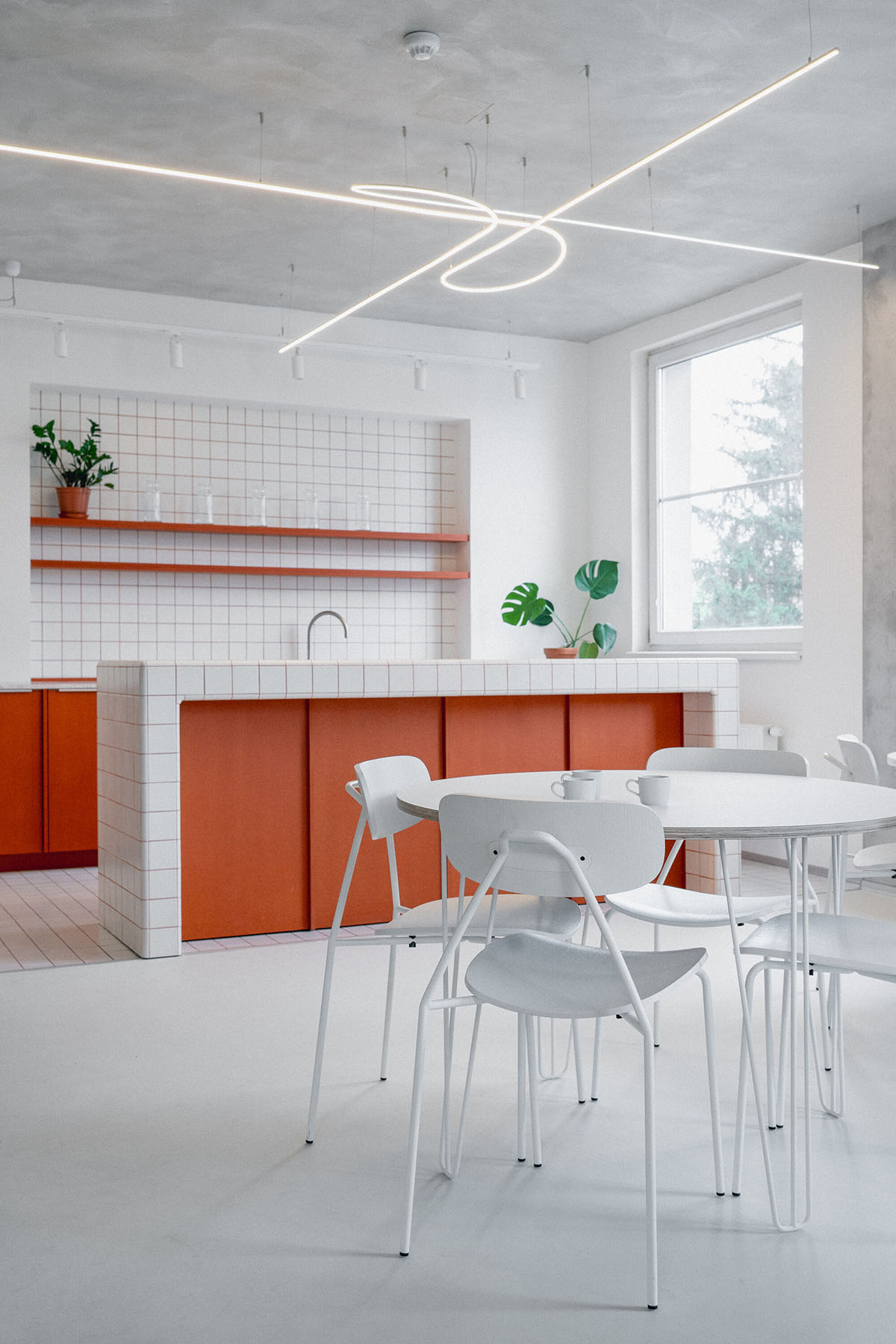 Studio Cosmo revitalizes Pudis offices featuring a stainless steel backdrop in Prague