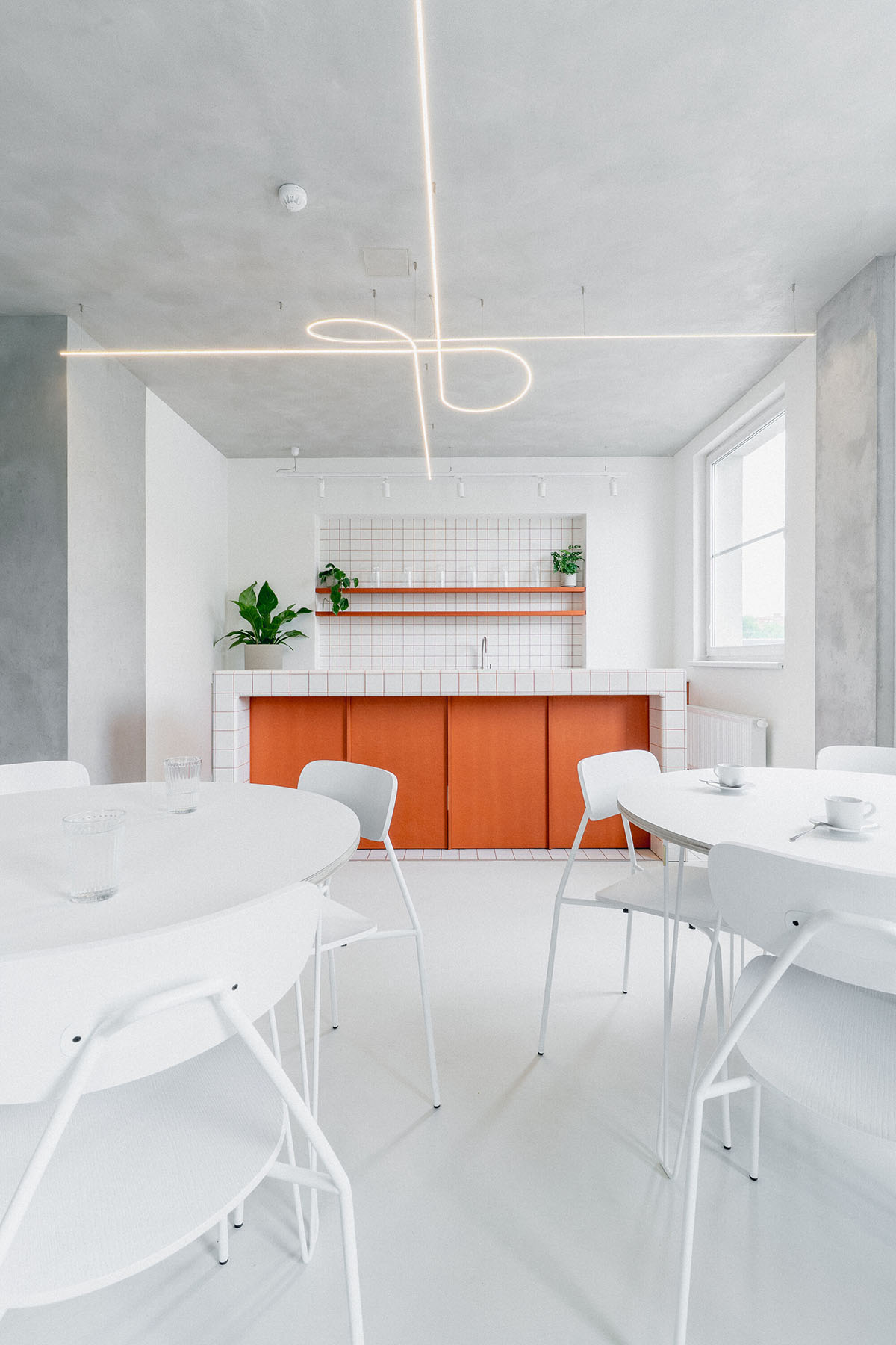 Studio Cosmo revitalizes Pudis offices featuring a stainless steel backdrop in Prague