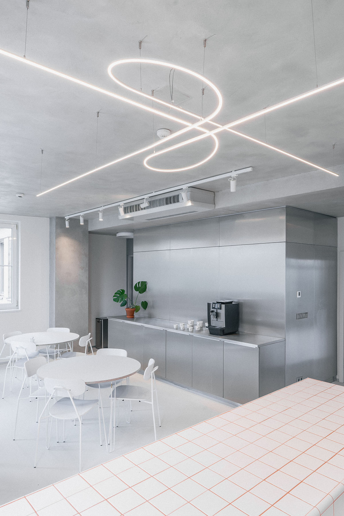 Studio Cosmo revitalizes Pudis offices featuring a stainless steel backdrop in Prague