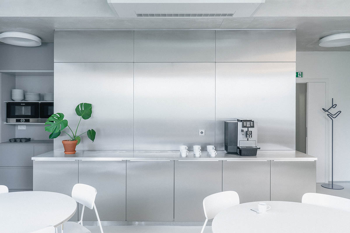 Studio Cosmo revitalizes Pudis offices featuring a stainless steel backdrop in Prague
