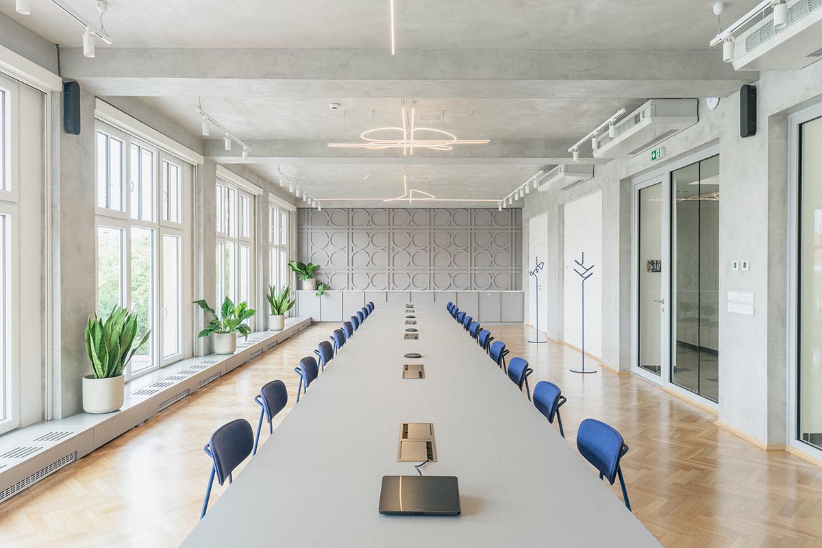 Studio Cosmo revitalizes Pudis offices featuring a stainless steel backdrop in Prague