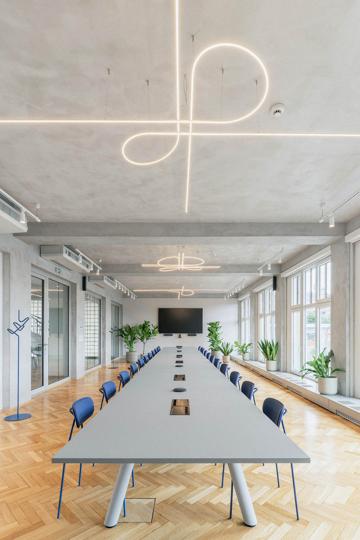 Studio Cosmo revitalizes Pudis offices featuring a stainless steel backdrop in Prague