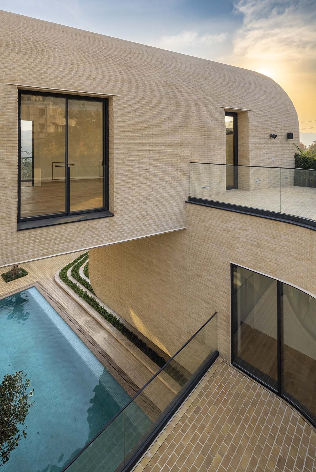 Tunnel-like villa is enhanced by reversed arch elements to define intricate courtyard in Iran