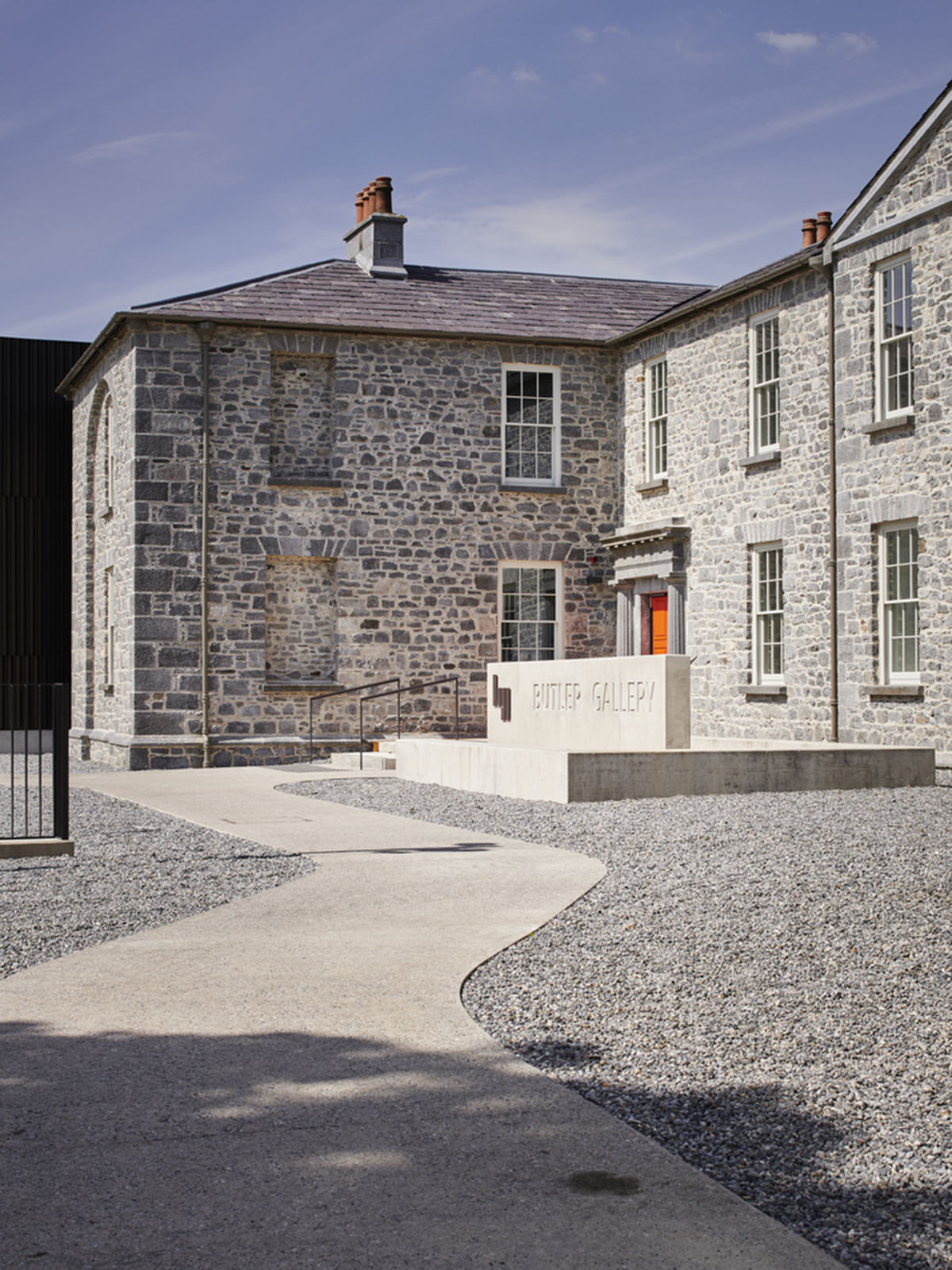 Mccullough Mulvin Architects adds two metal-clad volumes to convert former almshouse into art gallery
