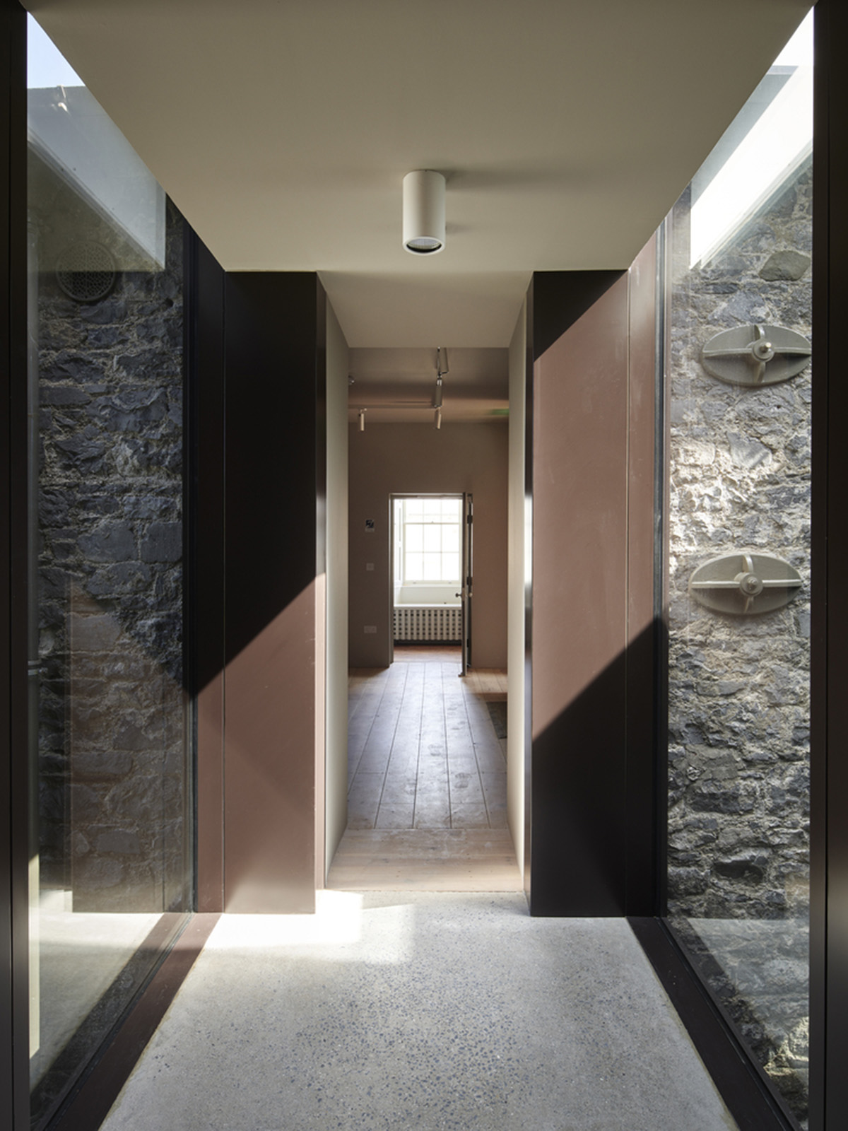 Mccullough Mulvin Architects adds two metal-clad volumes to convert former almshouse into art gallery