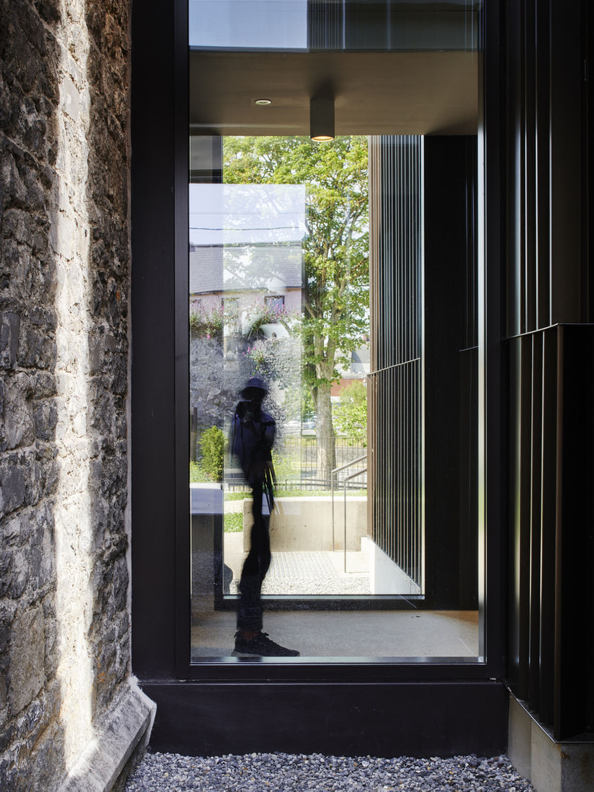 Mccullough Mulvin Architects adds two metal-clad volumes to convert former almshouse into art gallery