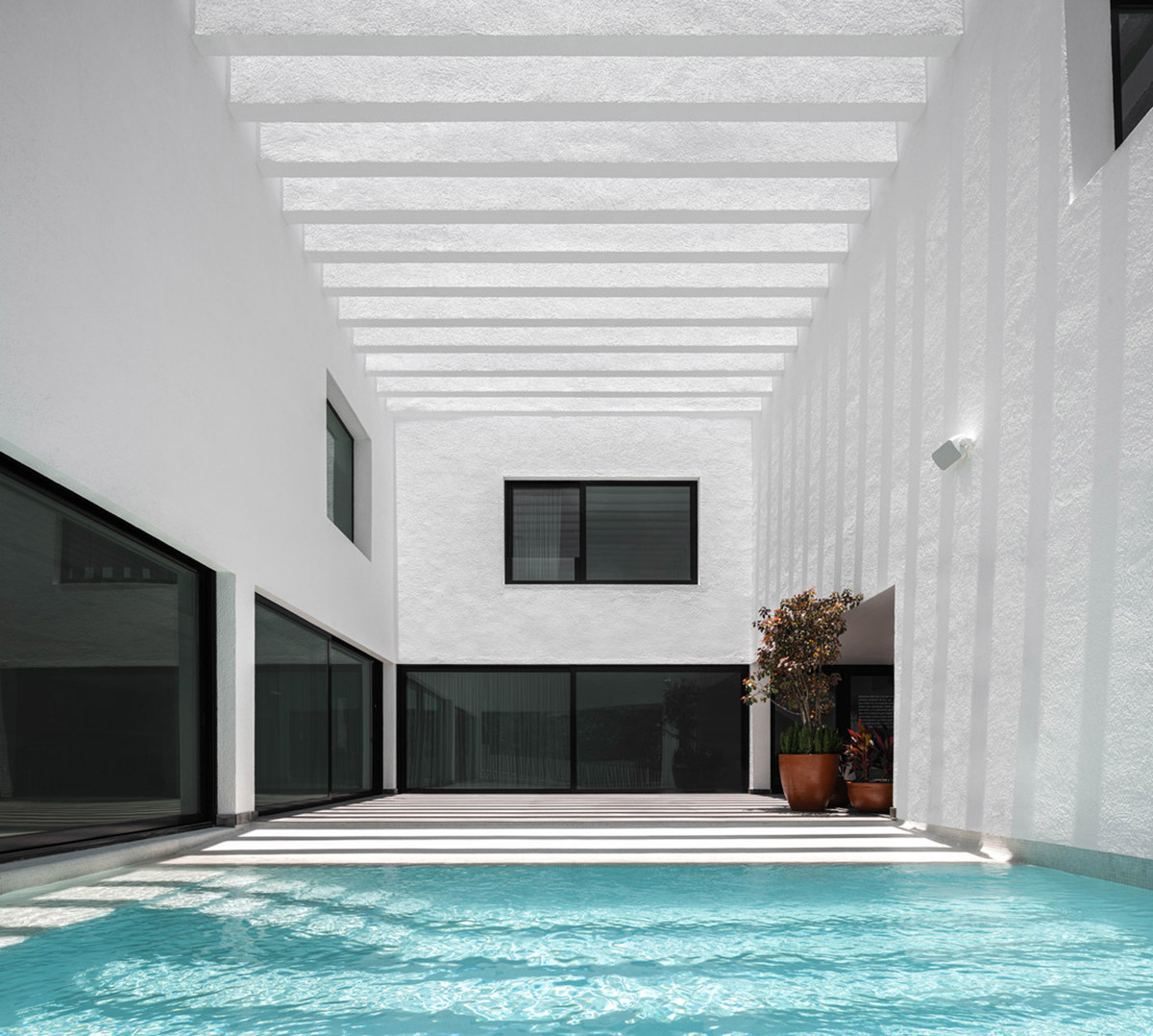 Cadaval & Solà-Morales' white excavated house features porous interior that expands activities