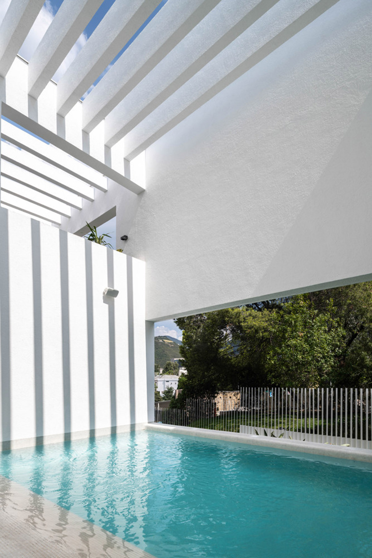 Cadaval & Solà-Morales' white excavated house features porous interior that expands activities