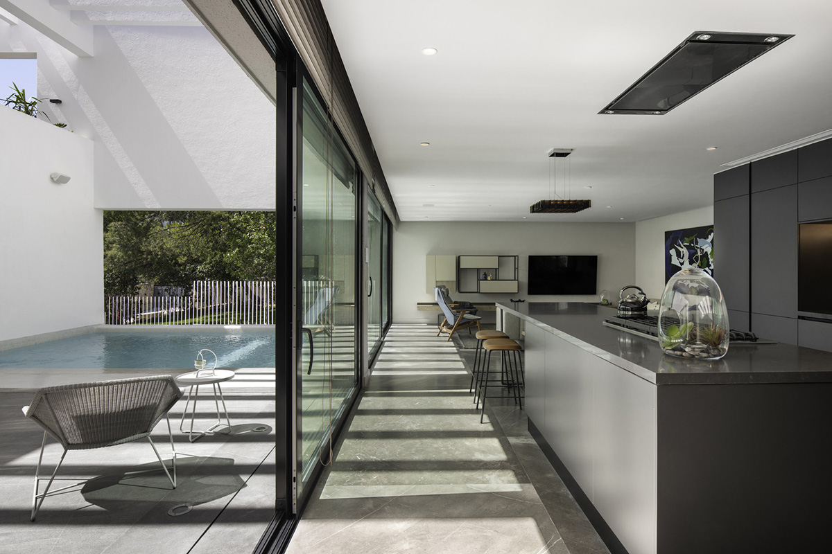 Cadaval & Solà-Morales' white excavated house features porous interior that expands activities