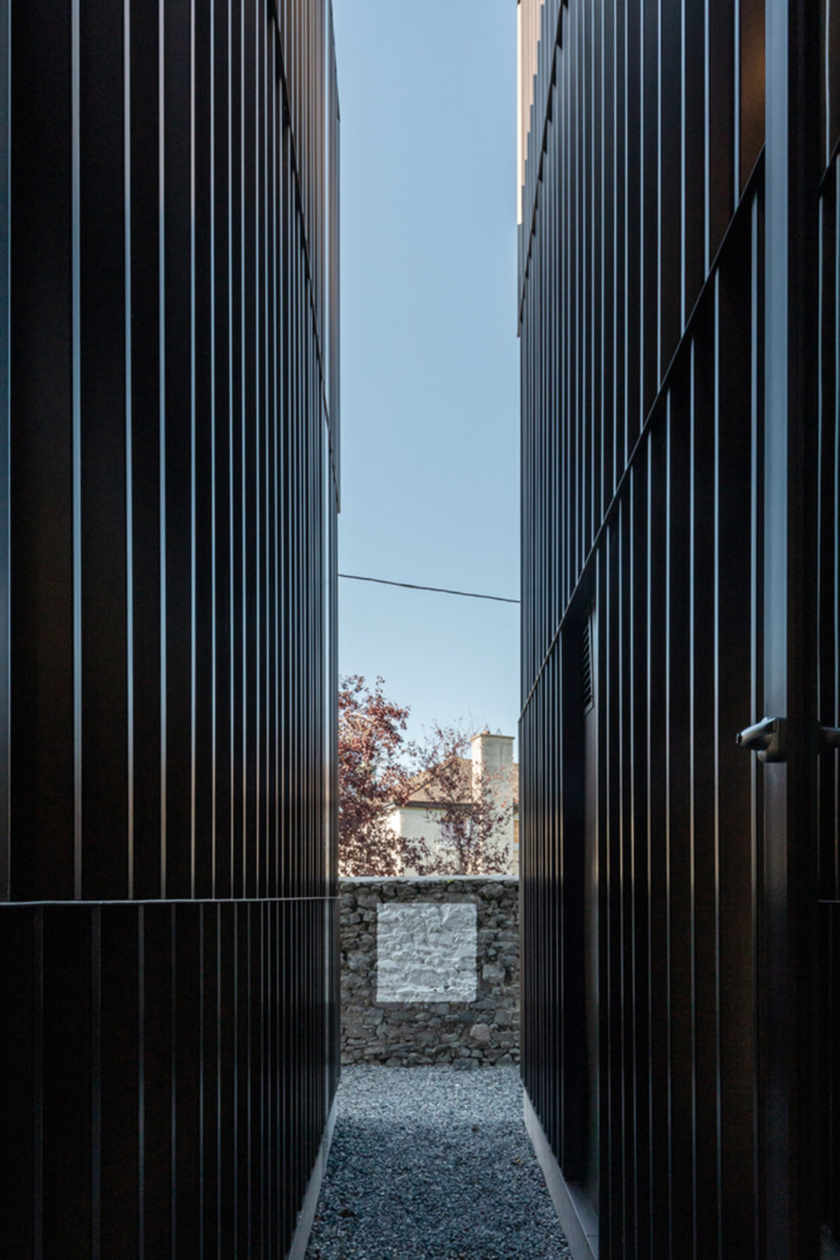 Mccullough Mulvin Architects adds two metal-clad volumes to convert former almshouse into art gallery
