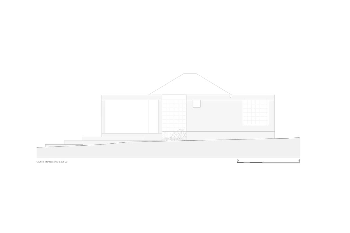 Rose-hued house by Práctica Arquitectura is topped with central roof to provide zenithal light 