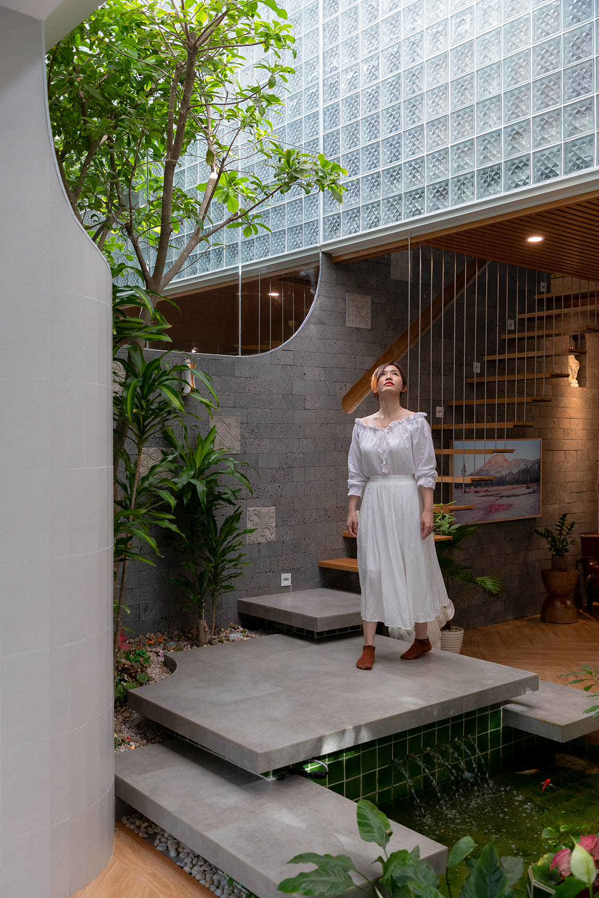 CoCo House, inspired by animated film, is clad in glass brick façade with wavy patterns in Vietnam