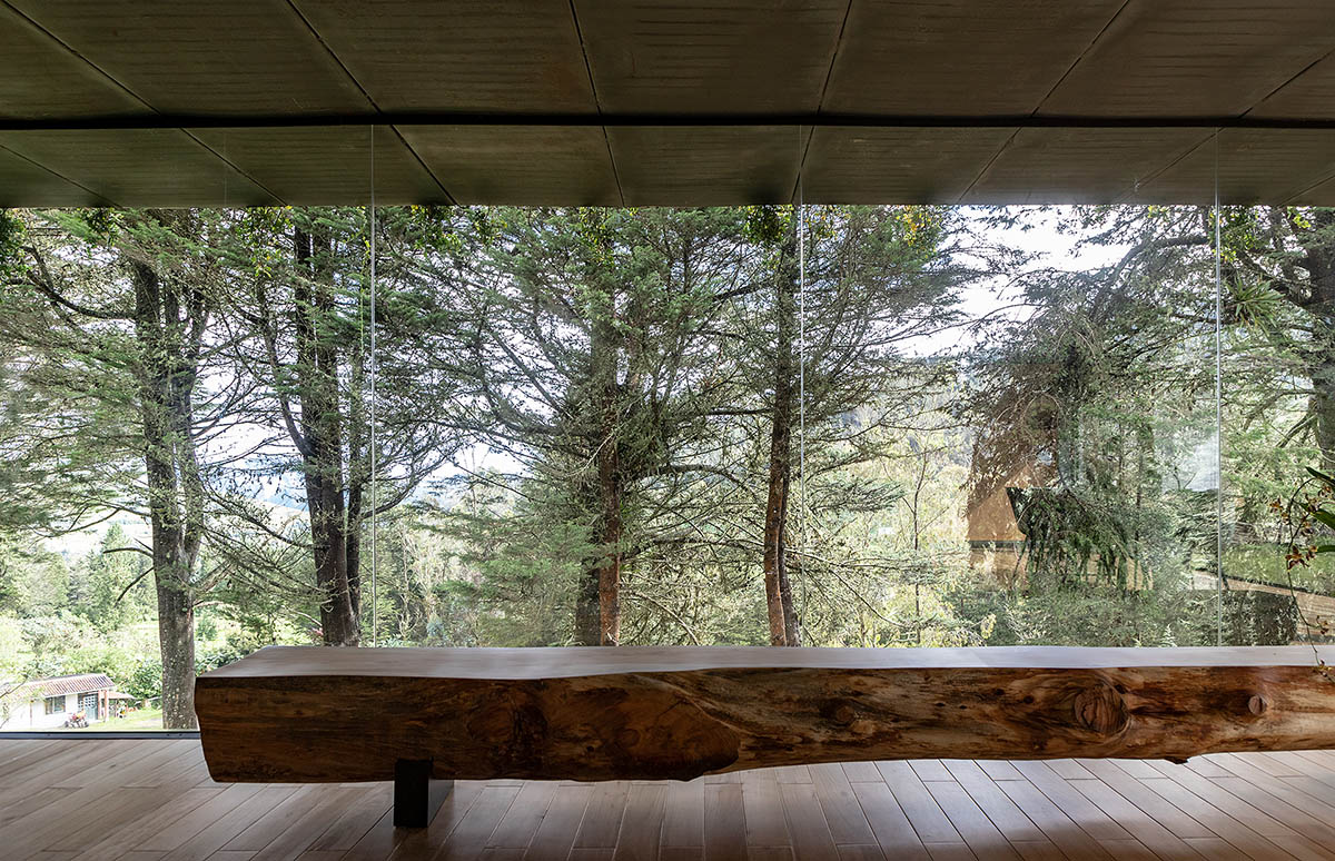 RAMA estudio built glazed retreat that sits on slope with minimal touch overlooking valley in Ecuador