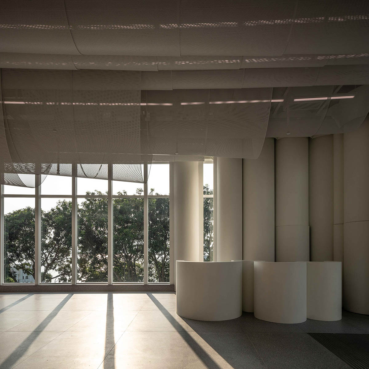 Atelier Nuno Architects suspends tubular aluminum panels from the ceiling of a lobby in Hong Kong
