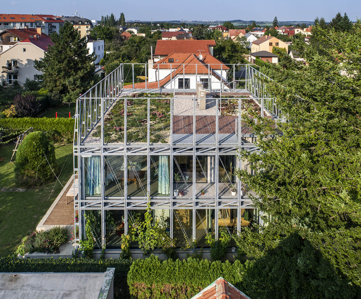 ŠÉPKA Architects wraps old residence with steel lattice featuring climbing plants as facade element